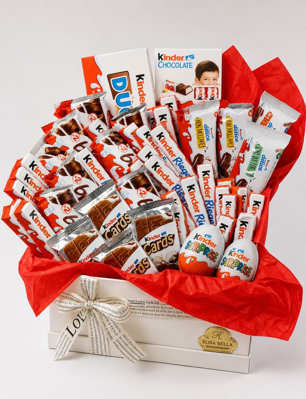 A white gift box packed with milk chocolate bars and novelty chocolates on red tissue paper.